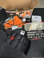 Electric planer, jig saw blade roll, bit kit on table