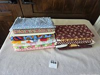 Overall stack of folded quilting fabrics on table