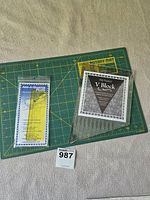 Overall lot showing two rulers and cutting mat