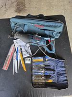 Bosch reciprocating saw with bag, blades, manual and blade roll displayed on table