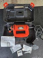 Open case showing rotary saw, power cord and accessories