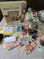 Overview of lot with pressed flowers kit, buttons, ribbons, lace and other notions