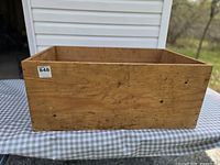 front and side view of the wooden box showing overall shape and exterior condition