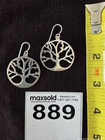 Front view of both earrings with measuring tape showing size