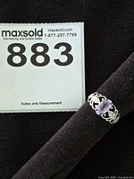 Full view of ring on mandrel with lot card