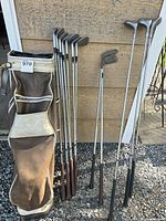 Full view of bag and all clubs leaning against wall