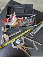 Overview of toolbox with assorted hand tools and clamps