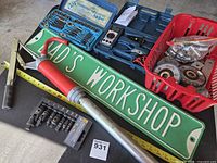 Overview of lot showing barrel pump, sign, tap and die set, flaring die block and measuring tape for scale