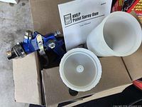 Power Fist paint spray gun with cups and manual