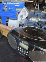 Lot overview showing radio, paint sprayer, drill case and brushes