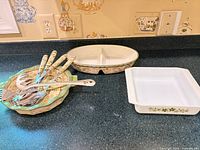 Entire lot, showing three ceramic dishes and six utensils