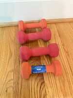 Four neoprene dumbbells on floor, top view