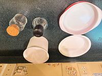 Group shot of all items: baking dish, two small dishes, two glass bottles