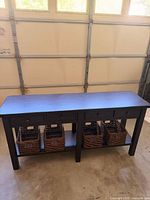 front view of console table with baskets on shelf