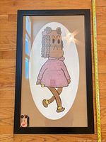 Front view of framed artwork showing character