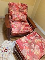 Front view of chair, ottoman, lumbar pillow showing wood frame and patterned upholstery