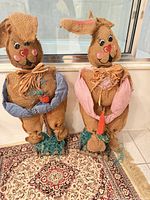Front view of both burlap bunny decorations standing on rug