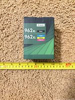 Front of sealed 4-pack 962XL ink cartridge box with measuring tape for scale