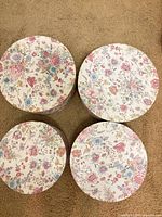 Top view of four matching floral hat boxes