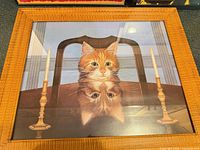 Orange tabby cat reflection print in wood-tone frame