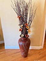 Ceramic floor vase with dried branch and faux flower arrangement