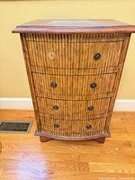 Full front view of dresser showing rattan front, drawer arrangement, missing pull