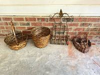 Full lot: two round wicker baskets, metal wall rack, heart-shaped basket