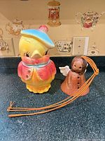 Cookie jar and angel bell side by side