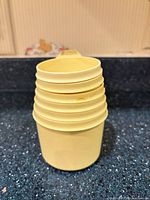 Stacked yellow measuring cups showing exterior