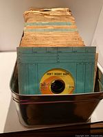 front view of tin showing records and label 'Don't Worry Baby'