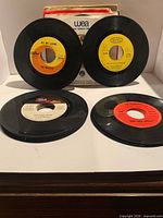 Front view showing several unsleeved 45s, WEA sleeve in background