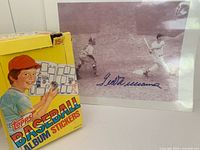 Box front and signed photo side by side