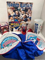 All items group shot showing book, can, cup, baseball in cube and duffel bag
