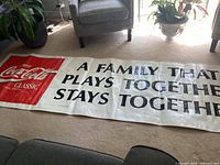 Full banner view on floor showing logo and slogan