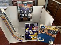 Front view showing all three books and one of the mini sticks