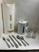 Overview of kettle, bag holder, sample flatware pieces and shakers