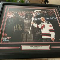Full view of framed, signed Martin Brodeur photograph with matting and plaque
