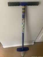 Full view of blue pogo stick standing upright
