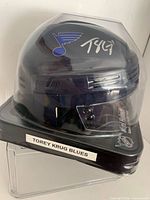 Full view of autographed blue mini helmet in sealed box labeled Torey Krug Blues
