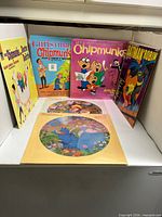 Front view of five LP jackets upright with two Disney picture discs in foreground