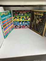 Group shot of three album covers upright