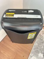 Front view of AmazonBasics shredder showing paper slot and waste bin