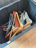 Top view of tote showing mix of wooden, metal, and plastic hangers