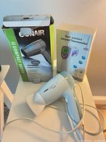 Group view showing Calor hair dryer, Conair dryer box, F101 thermometer box