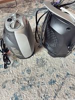 Both Lasko heaters side by side showing fronts, rears and power cords