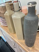 Front view of three ceramic bottles on countertop