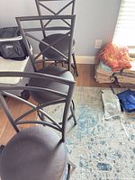 Three matching bar stools, full view showing frames, seats, backs