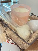 Basket containing jar candle, ball candles