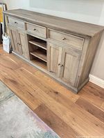 Front view showing entire sideboard including drawers, doors and open shelving