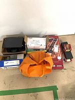 Overall view showing boxed SignPro kit, fastener boxes, orange bag, camera and GPS boxes